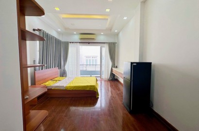 Wooden floor serviced apartment for rent with balcony on Huynh Van Banh street